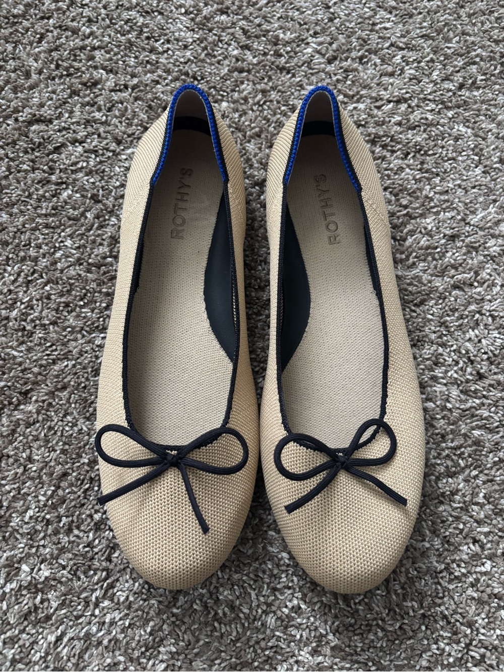Rothy's Beige Ballet Flats with Black Trim and Blue Heel Accent